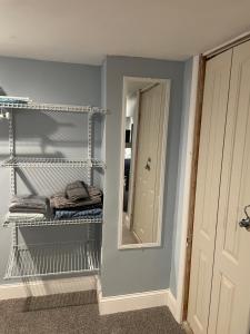 a room with a mirror and a shelf with towels at Downtown Suite - Close to Topgolf, Horseshoe Casino, UM Baltimore in Baltimore +33 photos