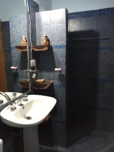 a bathroom with a white sink and a shower at Casa en Playas de Oro in San Antonio de Arredondo