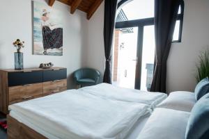 A bed or beds in a room at Bagoly Wellness Apartman 2
