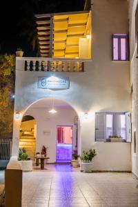 an entrance to a building with an archway at SantoriniNY in Perissa