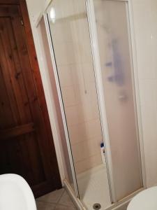 a shower with a glass door in a bathroom at Terrazza sul mare climatizzata in Villaputzu