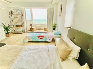 a bedroom with a bed and a view of the ocean at Sea View Studio in Constanţa