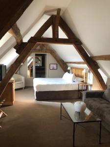A bed or beds in a room at Hôtel Saint-Laurent, The Originals Relais