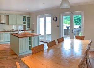 a kitchen with a wooden table and a dining room at Churchmount Holiday Home Roundwood in Wicklow