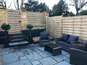 a patio with two chairs and a fence at Luxury House, central Stamford with parking in Stamford