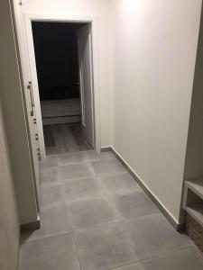 an empty hallway with a tile floor in a room at Apartmán Lipno in Lipno nad Vltavou