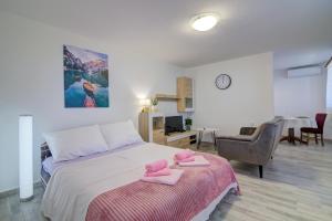 a bedroom with a bed with pink towels on it at Apartments Maria in Senj +40 photos