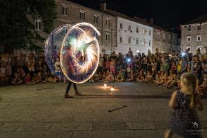 a man with a fire show in a crowd of people at Apartments Maria in Senj