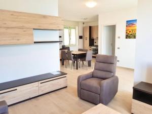 a living room with a television and a chair at Infinity Luxury in Lezzeno +18 photos