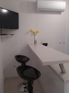 a room with a desk and a black stool at Apartman Sky in Pula