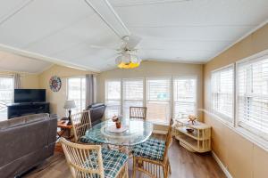 a living room with a table and chairs and a couch at Long Island Village Unit 347 in Port Isabel