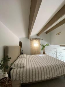 a bedroom with a bed and a balcony at Duplex FACE AU LAC à 600 mètres de la mer in Six-Fours-les-Plages