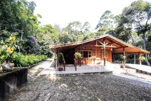 a small wooden building in the middle of a forest at Sitio Bom Tempo in Miguel Pereira