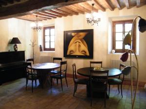 a dining room with two tables and a painting on the wall at Room and Breakfast Torre in Felino