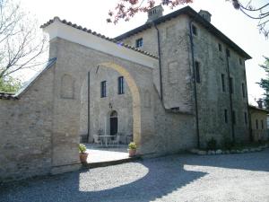 a large brick building with an archway on it at Room and Breakfast Torre in Felino