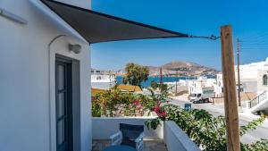 a view from the balcony of a house with a black umbrella at Vista Mare in Naousa
