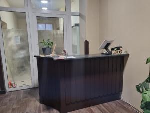 an office with a reception desk with a laptop on it at Pension Torgau in Torgau
