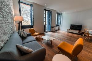 a living room with a couch and a tv at 403 · Wonder Appart' - Vue sur Garonne - in Toulouse