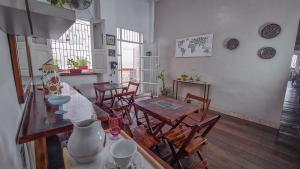 a dining room with a table and chairs and a table and chairsktop at Aldeia Hostel in Manaus