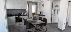 a kitchen with a table and chairs in a room at Village Dream-Rhodes Airport in Paradeísion