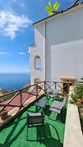 a patio with two chairs and a table on a roof at Villa Matilde Amalfi in Amalfi