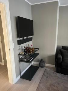 a living room with a television on a shelf at Luxury new apartment - Heart of Copenhagen in Copenhagen