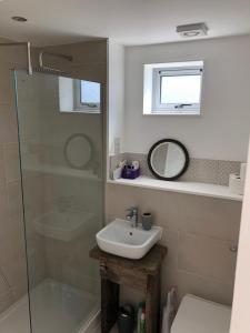 a bathroom with a sink and a shower at The Shack in East Wittering +31 photos