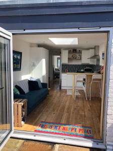 a view of a living room and kitchen from inside a garage at The Shack in East Wittering