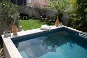 a swimming pool in the backyard of a house at SOUS LE TILLEUL à RUOMS in Ruoms