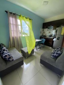 a living room with two couches and a table at RESIDENCIAL DOÑA GLORIA in San Felipe de Puerto Plata