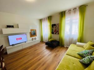 a living room with a couch and a flat screen tv at Mutti Stay apartments in Riva del Garda