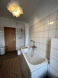 a bathroom with a tub and a shower in it at ~In der Natur und dennoch zentral~ in Annaberg-Buchholz