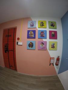 CoCo Guesthouse Kemaman في Cukai: غرفة بها جدار مع صور على الحائط