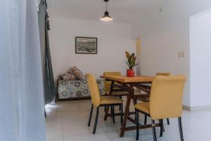 a dining room with a wooden table and chairs at La Tranquila in Pergamino