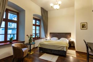 a bedroom with a bed and two windows at ZEPPELIN APARTMENTS Simple Acomodation in Jelenia Góra