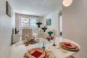 a dining room table with wine glasses on it at Appartement Clap d'Or - Welkeys in Cannes