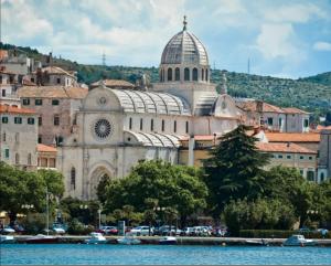 a large building with a dome on top of a city at Apartments Grubišić - Šibenik - parking included in Šibenik