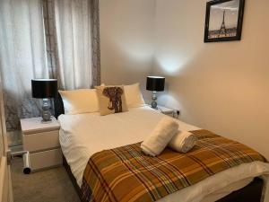 a bedroom with a bed with two night stands and two lamps at Luxury Modern Belfast City Centre 2 Bed Apartment in Belfast