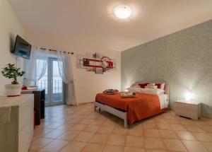 A bed or beds in a room at B&B Santa Giusta