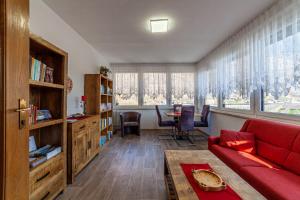 a living room with a red couch and a table at Residence Sonja in Naturno