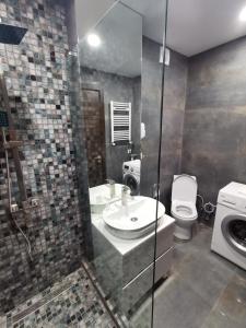 a bathroom with a sink and a toilet at ArchiC509 in Tbilisi City