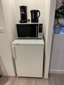 a microwave oven sitting on top of a refrigerator at Chez la p'tite Marie in Savigny-lès-Beaune +13 photos