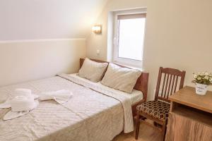 a small bedroom with a bed and a window at Mandarin Restoran & Hostel in Haapsalu
