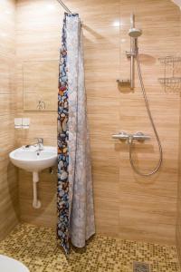 a bathroom with a shower curtain and a sink at Mandarin Restoran & Hostel in Haapsalu