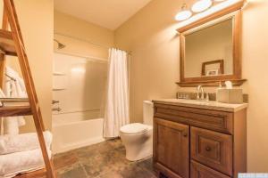 a bathroom with a toilet and a sink and a mirror at Spencertown Inn in Spencertown