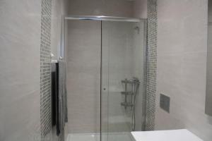 a shower with a glass door in a bathroom at Casa Onda Spot in Nazaré +14 photos