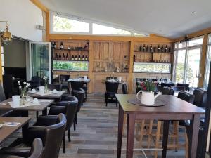 a dining room with tables and chairs and windows at Usedom Bike Hotel & Suites in Ostseebad Karlshagen