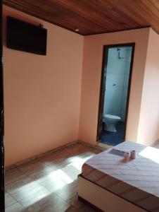 Postel nebo postele na pokoji v ubytování Hotel Palace Vila Sônia