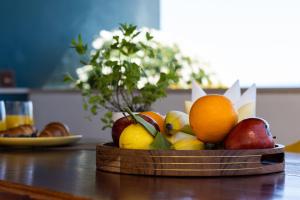 a wooden bowl of fruit on a table at Apartment Horizon in Split