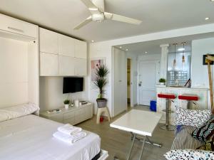 Apartament obejmuje sypialnię z łóżkiem oraz salon z wentylatorem sufitowym. w obiekcie Estudio Deluxe Primera Línea CHINASOL w Almuñécar